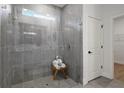 This luxury bathroom features a walk-in shower with grey tile and glass divider at 6760 Sw 128Th Loop, Ocala, FL 34473