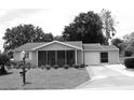 Charming single-story home featuring a screened-in porch, well-manicured lawn, and attached garage at 8650 Sw 108Th Pl, Ocala, FL 34481