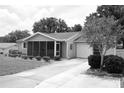 Charming single-story home featuring a screened-in porch, well-manicured lawn, and attached garage at 8650 Sw 108Th Pl, Ocala, FL 34481