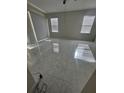 Bright living room featuring neutral walls, tile flooring, and plenty of natural light at 9238 Sw 60Th Court Rd, Ocala, FL 34476