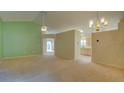Spacious living room with neutral carpet, high ceilings, ceiling fan and bright, airy feel at 949 Woodsong Way, Clermont, FL 34714