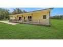 View of the covered front porch with wood posts and railing on this country home at 975 Cr 542E, Bushnell, FL 33513