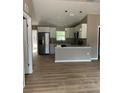 Open kitchen featuring stainless steel appliances, granite countertops, and modern lighting at 10375 Se 126Th Ln, Belleview, FL 34420