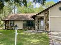 Lovely home with stone detailing, an attached garage, and manicured landscaping at 1112 Ne 130Th Ter, Silver Springs, FL 34488