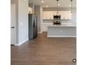 Open-concept kitchen featuring stainless steel appliances, a center island, and sleek countertops at 13145 Sw 78Th Cir, Ocala, FL 34473