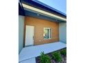 Modern home exterior showing the front entrance with a white door and clean architectural lines and landscaping at 13239 Sw 60Th Avenue Rd, Ocala, FL 34473