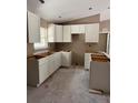 Unfinished kitchen featuring modern white cabinets, ready for appliances and countertops, filled with natural light at 21712 Sw Rainbow Lakes Blvd, Dunnellon, FL 34431