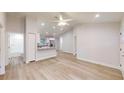 Spacious living area with wood floors leading to a bathroom and modern kitchen with stainless steel appliances at 2264 Sw Moines Ct, Dunnellon, FL 34431