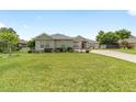 Well-manicured front yard with mature landscaping, bushes and plants, complimenting this single story home at 2413 Se 23Rd St, Ocala, FL 34471