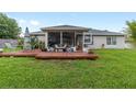 Back patio features plenty of room for seating among plants and other decorations overlooking backyard at 2413 Se 23Rd St, Ocala, FL 34471
