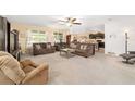 Spacious living room with abundant natural light and two large couches. Includes ceiling fan and neutral walls at 2552 Ne 42Nd Rd, Ocala, FL 34470