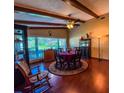 Dining room featuring hardwood floors, wood beams, a ceiling fan and natural light from windows at 3545 Se 24Th Ave, Ocala, FL 34471
