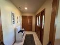 Inviting entryway with tiled floor, wood accents, a storage bench and closet for added convenience at 3545 Se 24Th Ave, Ocala, FL 34471