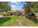 Beautifully landscaped front yard with lush green grass and mature trees surrounding the home at 4300 Nw 4Th Cir, Ocala, FL 34475
