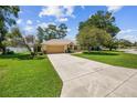 Well-manicured front lawn leading to a single-story home with a two-car garage at 4300 Nw 4Th Cir, Ocala, FL 34475