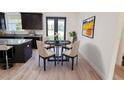 Cozy dining area featuring a round table with four chairs next to a kitchen with backyard views at 7 Hill Prince Dr, Ocala, FL 34482