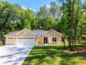 Charming single-story home with a well-manicured lawn, three-car garage and a classic architectural style at 7695 Sw 188Th Ave, Dunnellon, FL 34432