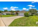 Well-maintained single Gathering home with a green lawn, driveway, and lovely landscaping at 8 Diamond Club Rd, Ocala, FL 34472