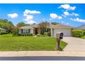 Well-maintained home featuring verdant lawn, pruned shrubs, and a beige mailbox at 8 Diamond Club Rd, Ocala, FL 34472