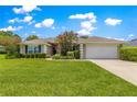 Beautiful lawn with decorative trees and shrubs leading to the home's entrance at 8 Diamond Club Rd, Ocala, FL 34472