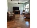 Cozy living room with hardwood floors, a ceiling fan, and comfortable seating at 8320 Sw 108Th Place Rd, Ocala, FL 34481
