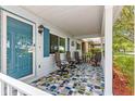 Inviting front porch with unique tile flooring and ample seating, perfect for relaxing at 8400 Sw 90Th St # C, Ocala, FL 34481