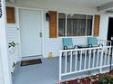 Close-up view of the well decorated front porch with comfortable seating and a 'welcome' doormat at 8547 Sw 106Th Pl, Ocala, FL 34481