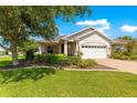 Beautiful single-story home with manicured lawn and landscaping, complemented by a paver driveway at 8566 Sw 83Rd Loop, Ocala, FL 34481