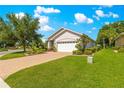 Well-maintained lawn and landscaping highlight this single-story home, with a paver driveway and mature trees at 8566 Sw 83Rd Loop, Ocala, FL 34481