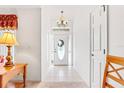 Bright entryway with tiled floors, chandelier, and a glass-paneled front door at 10151 Sw 41St Ter, Ocala, FL 34476