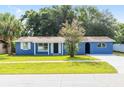 Charming single-story home with blue exterior, well-maintained lawn, and mature landscaping at 14761 Sw 35Th Terrace Rd, Ocala, FL 34473