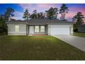 Charming single-story home featuring a well-manicured lawn and an attached two-car garage at 15212 Sw 27Th Ct, Ocala, FL 34473