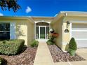 Close-up of a home's front entrance featuring a decorative glass door and manicured landscaping at 15822 Sw 16Th Avenue Rd, Ocala, FL 34473