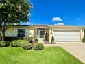 Inviting single-story home with a well-maintained lawn, attractive landscaping, and a welcoming entrance at 15822 Sw 16Th Avenue Rd, Ocala, FL 34473