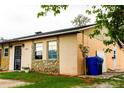 Charming single-story home featuring stone accents, neat landscaping, and a driveway at 2563 Coral Ave, Kissimmee, FL 34741