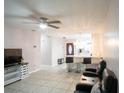 Spacious open-plan living room flows into the kitchen, featuring sleek tile floors at 2563 Coral Ave, Kissimmee, FL 34741