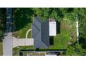 This aerial shot offers a bird's-eye view of the home with its large backyard and detached garage at 26 Hemlock Terrace Dr, Ocala, FL 34472