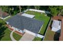 This aerial view showcases the home, a well-kept lawn, a fenced backyard, and a detached garage at 26 Hemlock Terrace Dr, Ocala, FL 34472