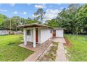 Rear exterior showcasing a stucco-clad home with a well-maintained lawn at 2602 Ne 2Nd Ave, Ocala, FL 34470
