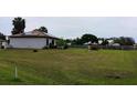 Expansive backyard featuring a freshly mowed lawn and a classic white fountain at 313 Oak Track Trce, Ocala, FL 34472