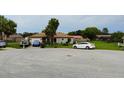 Residential street showcasing a single-story home with a well-kept front yard and ample parking at 313 Oak Track Trce, Ocala, FL 34472