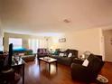 Spacious living room with hardwood floors, a ceiling fan, and comfortable seating at 3525 E Fort King St # 140, Ocala, FL 34470
