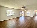 Large living room featuring dark wood floors and ceiling fans at 3525 E Fort King St # 145, Ocala, FL 34470