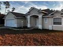 Charming single-story home with stucco exterior, manicured lawn, and attached two-car garage at 3858 Sw 161St St, Ocala, FL 34473