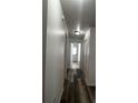 Hallway featuring new flooring, fresh paint and doors leading to other rooms in the home at 3858 Sw 161St St, Ocala, FL 34473