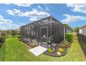 Spacious screened patio surrounded by a manicured lawn and garden, offering privacy and relaxation at 4340 Nw 56Th Ct, Ocala, FL 34482