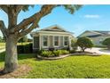 A view of the front yard featuring landscaping and a large tree near the home's entrance at 5093 Nw 35Th Lane Rd, Ocala, FL 34482