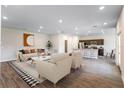 Open-concept living room showcasing modern furniture, stylish decor, and wood-look flooring at 585 Marion Oaks Pass, Ocala, FL 34473