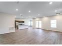 Spacious living area with modern finishes, wood-look flooring, and an open view to the kitchen at 585 Marion Oaks Pass, Ocala, FL 34473
