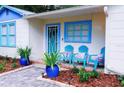 Welcoming front porch with seating, colorful accents, and a beautifully landscaped garden at 626 Ne 21St St, Ocala, FL 34470